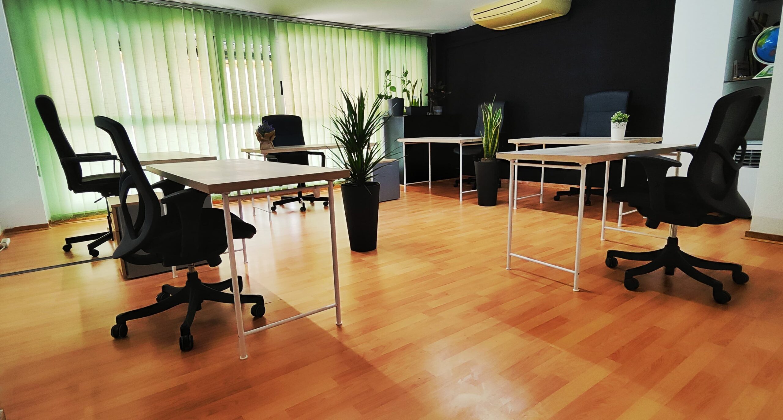 Espacio de trabajo compartido con mesas amplias, sillas ergonómicas y plantas decorativas en Tecni Estudio Coworking